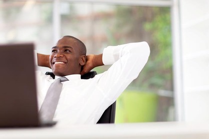 happy african american businessman relaxing in office